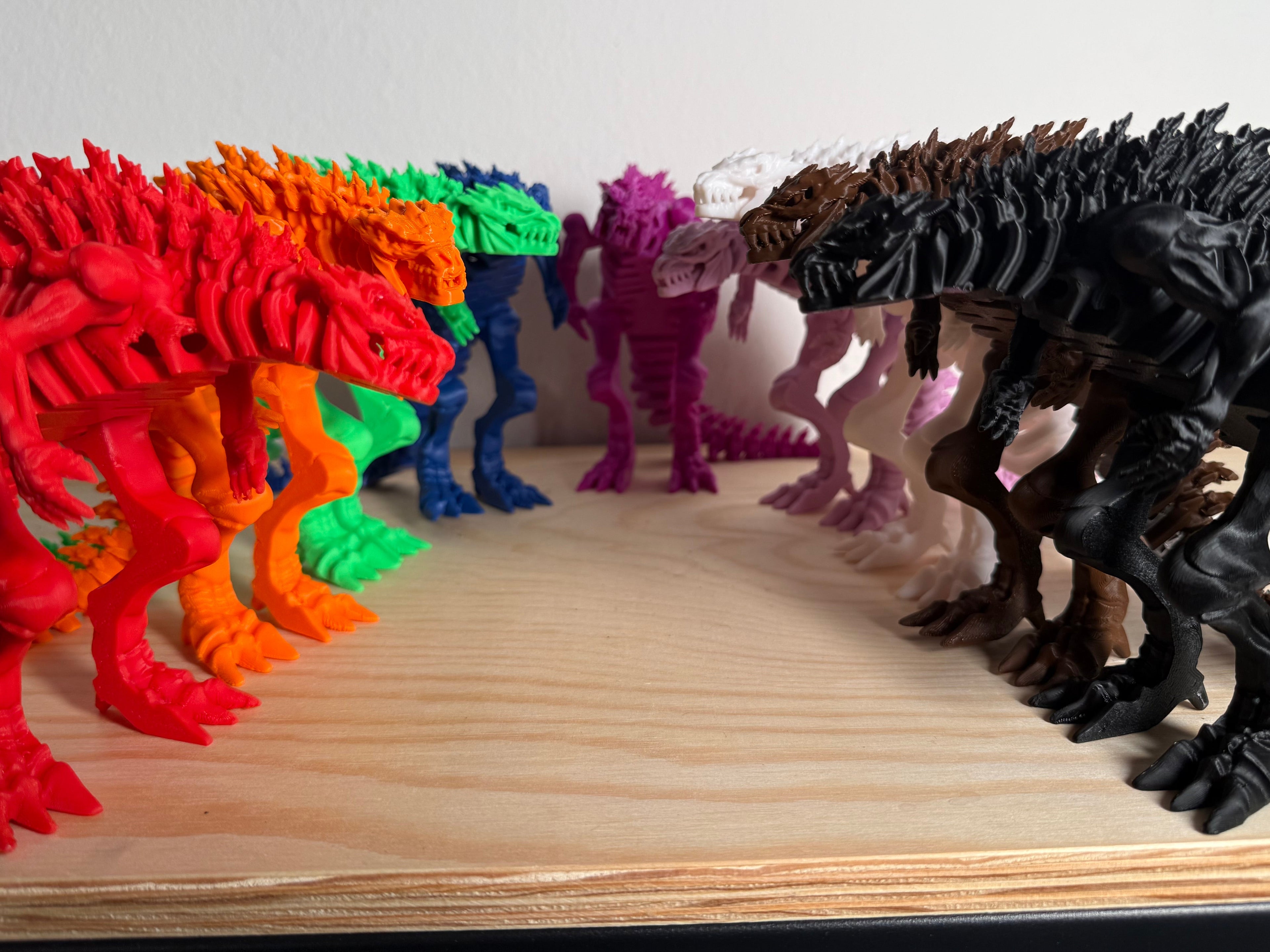 Colorful dinosaur toy figures on a wooden surface with a white background